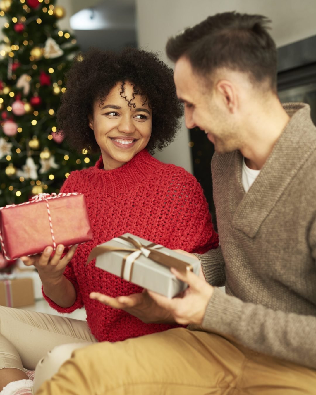 Happy couple sharing the Christmas presents